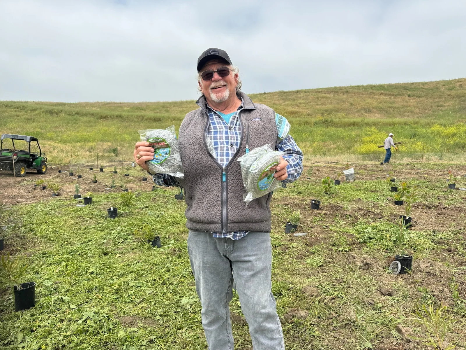 Ben Gill smiling in a newly planted field