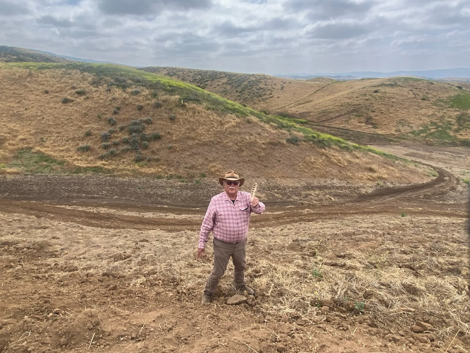 Ben standing on an open hillside during the early development of the farm